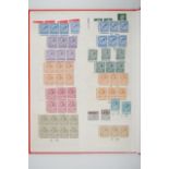 A Stanley Gibbons red stock book containing many mint GB stamps including KGV in cylinder blocks,