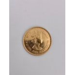 A 1971 Mauritius 200 Rupees gold coin, 15.5 g