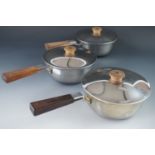 A set of three 1930s Georg Jensen stainless steel sauce pans and covers, designed by Harold Nielsen,