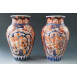 A pair of Meiji Japanese Imari vases, of lobed inverted baluster form, decorated with a cockerel