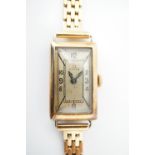 A lady's 14ct gold cased Omega wrist watch, having a brushed silver face and Arabic numerals, in a