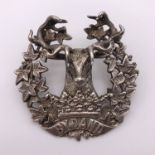 A Gordon Highlanders silver bonnet / cap badge, bearing retailer's stamp of A & J Smith of Aberdeen,