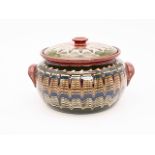 A craft pottery slipware casserole pot, 14 cm x 24 cm