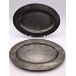 Two antique pewter oval dishes bearing London touch marks, 40 cm x 29 cm