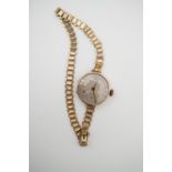 An early 20th Century lady's 9ct gold cased wristlet watch, having a silvered face with Arabic