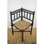 A late 19th / early 20th Century turned and rush-seated corner chair