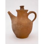 A hand raised and turned terracotta jug and cover, having a blue glazed interior, 23 cm