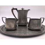 An Arts and Crafts Craftsman Pewter planished coffee service, comprising coffee pot, milk jug, sugar