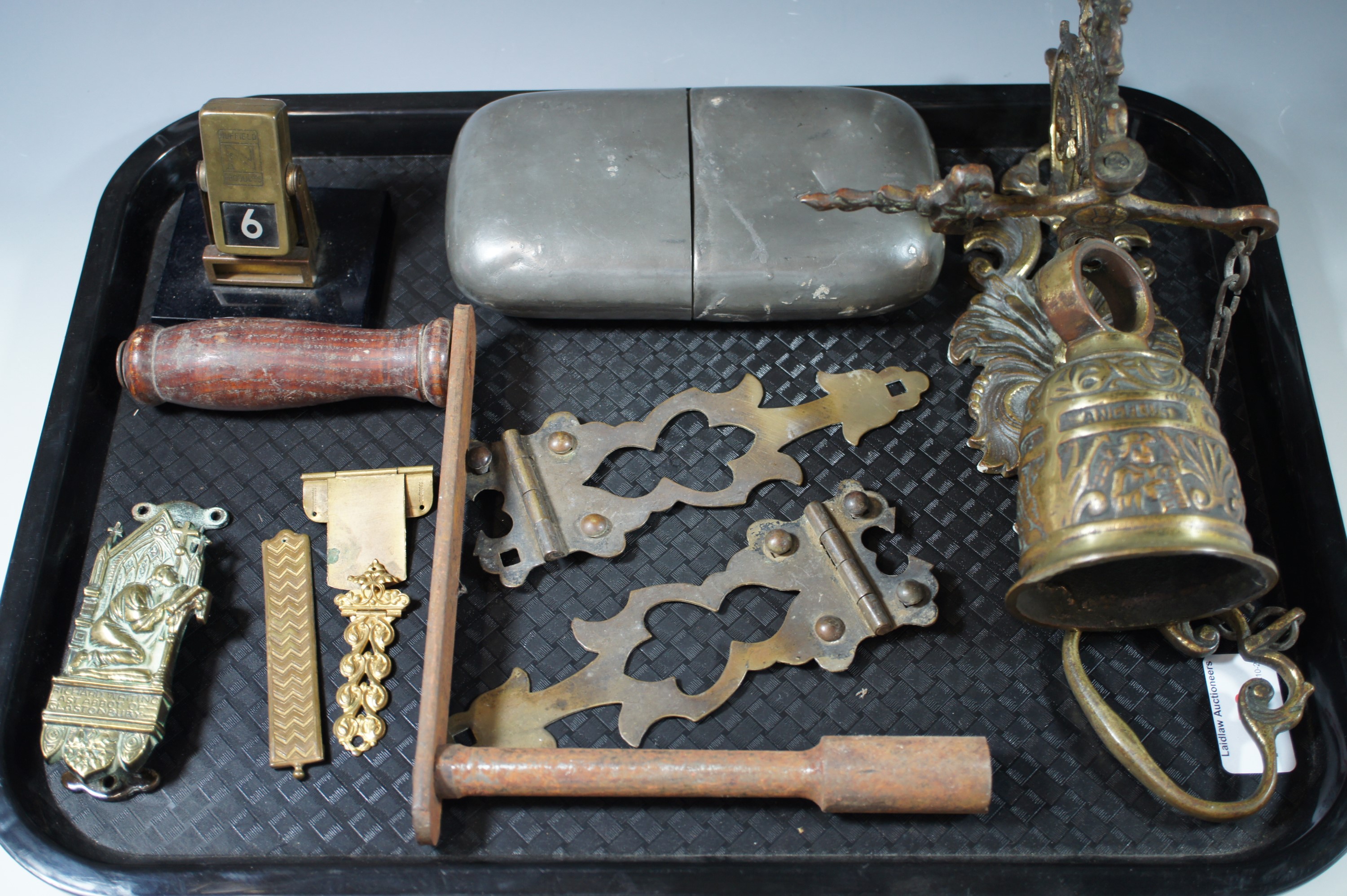 A brass door bell, door knocker, desk calendar, ornamental strap hinges etc