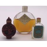 A vintage bottle of Worth of Paris "Je Reviens" perfume in a Lalique glass bottle, a small bottle of