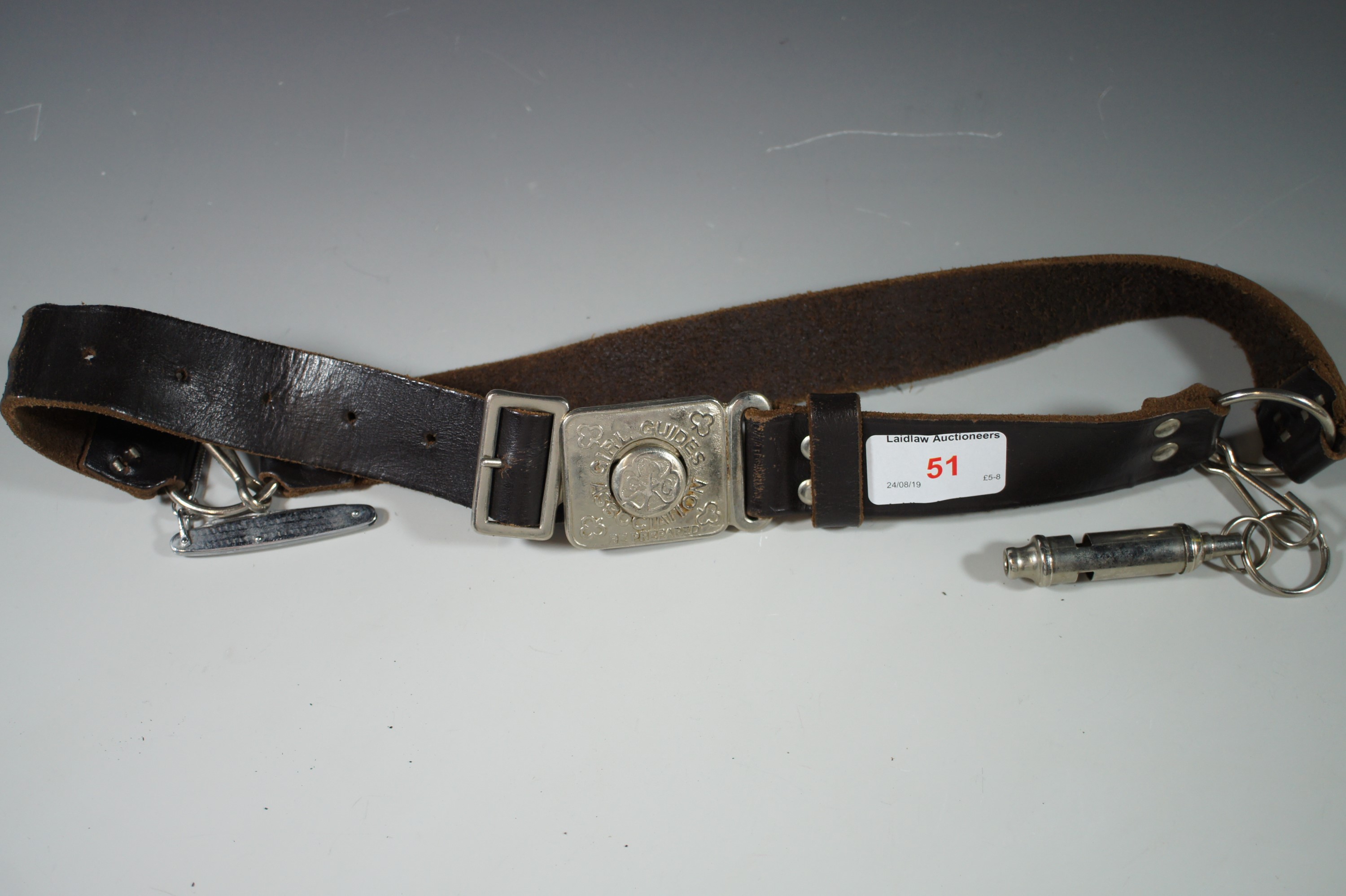 A Girl Guides belt with whistle etc