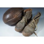 A vintage leather rugby ball and boots