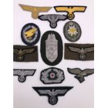 A quantity of reproduction Second World War German cloth insignia etc