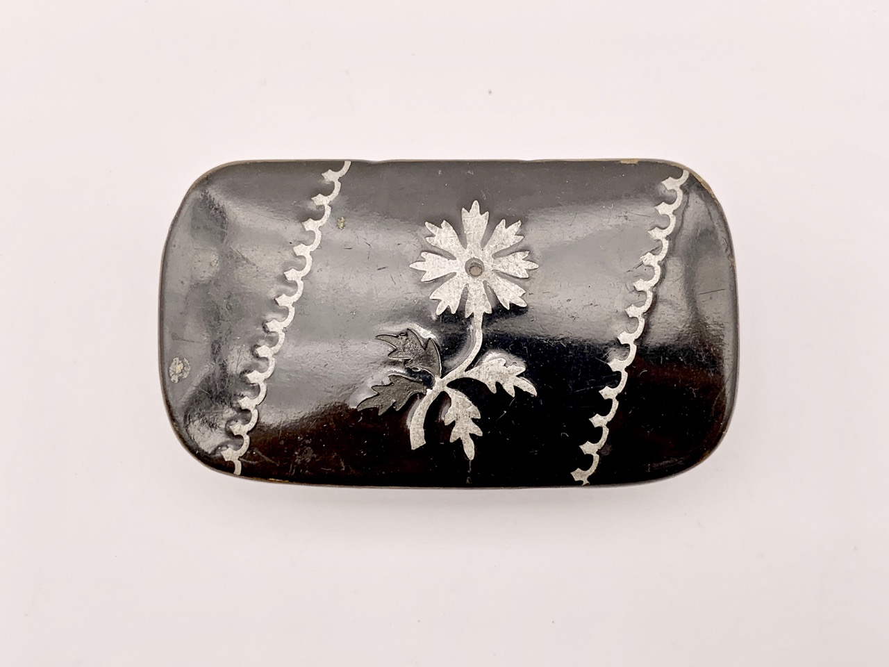 A Victorian pewter inlaid lacquered snuff box