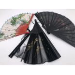 An Edwardian lady's hand fan of Aesthetic influence, having Japanned wooden sticks and a black gauze