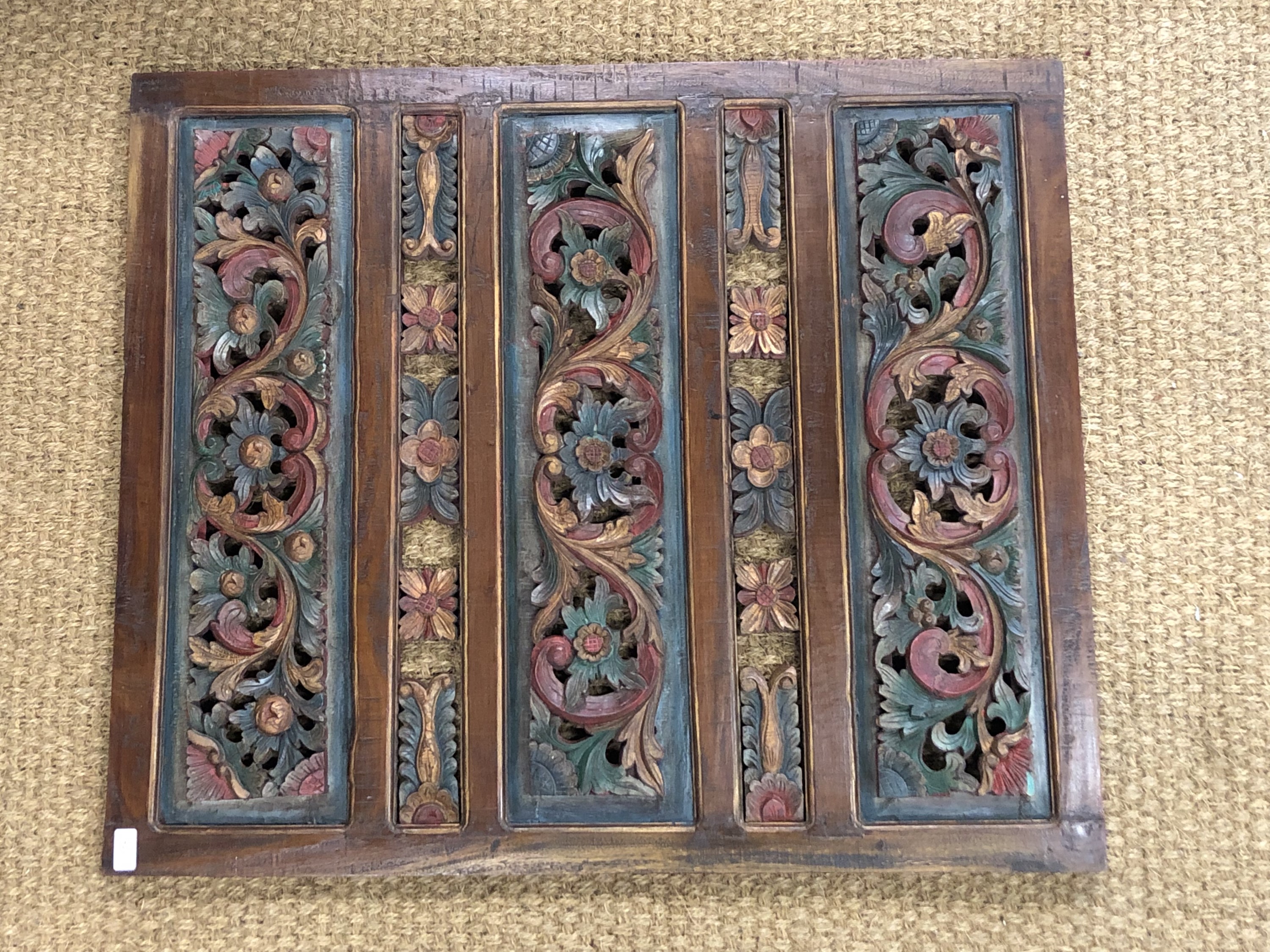 A large oriental carved wooden panel, 82 x 96 cm