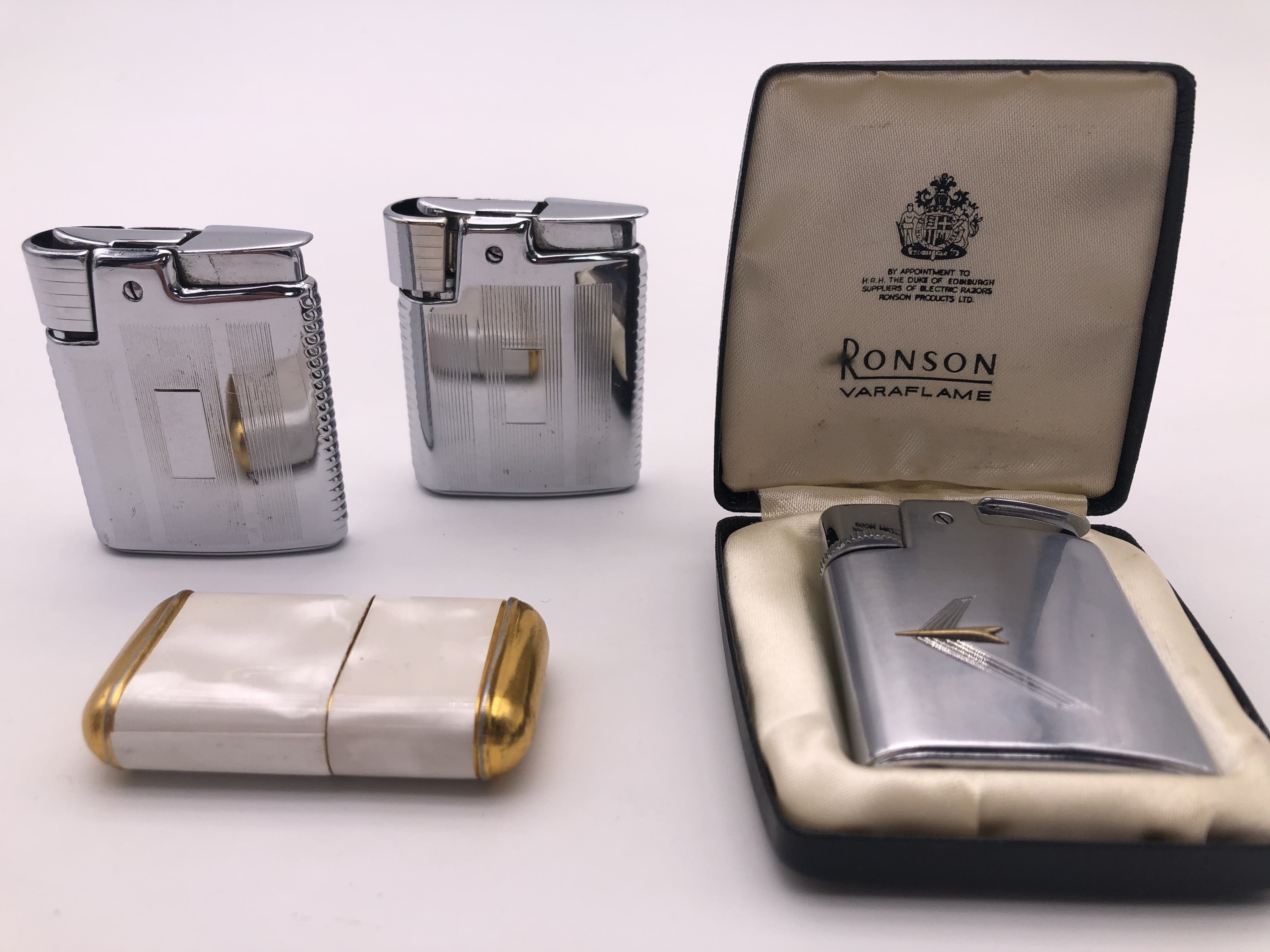 A vintage cased Ronson Varaflame cigarette lighter and others