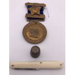 Collectors' items comprising a silver thimble, 1903 Cumberland schools attendance medal and pocket