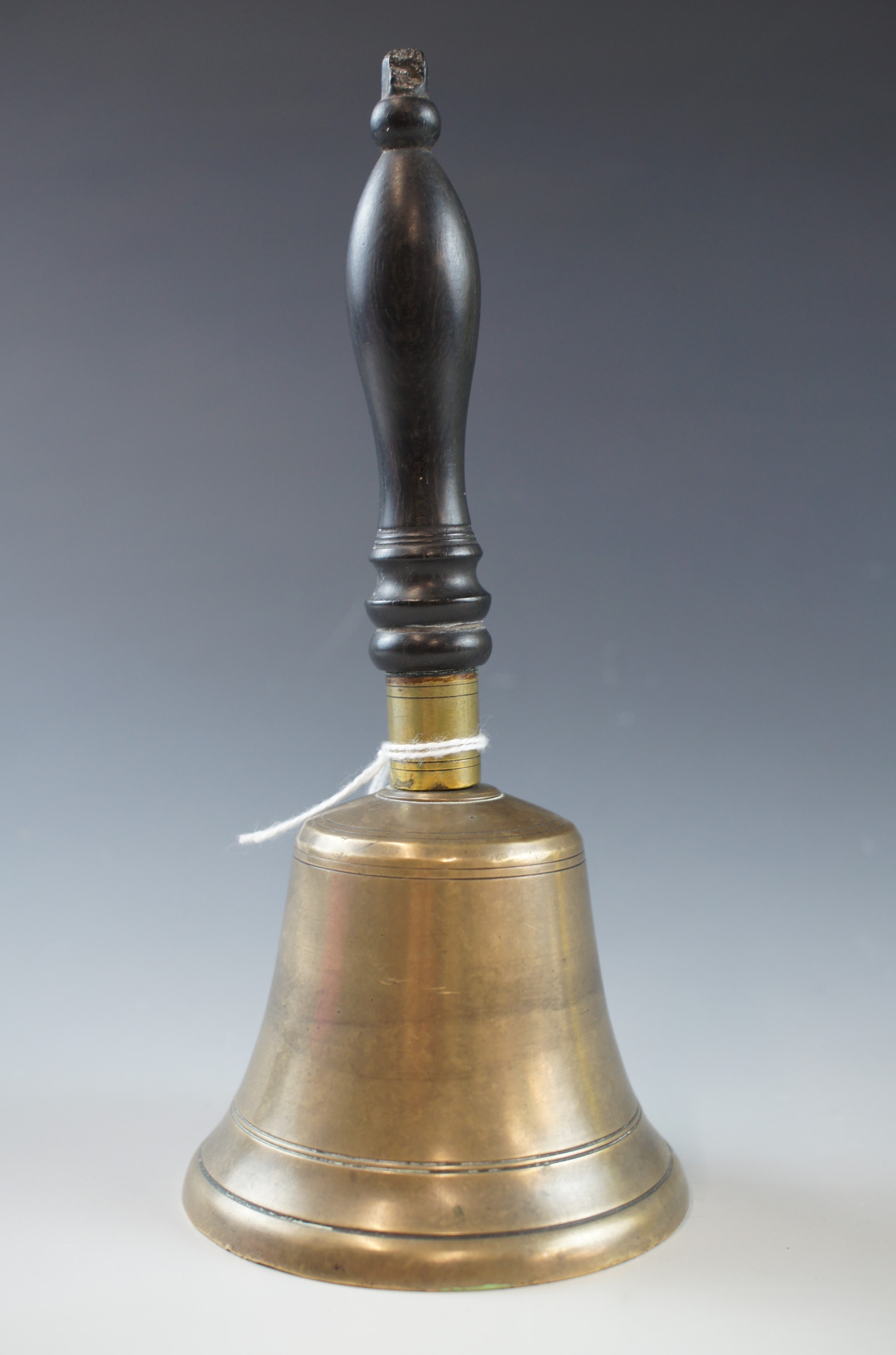 A Victorian brass hand bell with turned ebony handle