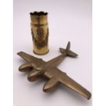 A trench art vase and brass aeroplane.