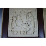 A South Asian pre-cast stone relief plaque in wooden frame and transit case, 54 x 54 cm framed