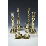 A pair of Victorian brass candlestick, a pair of double-helical brass candlesticks and two others,