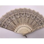 Two vintage hand fans, one having a tulle leaf with applied silver spangles and carved bone