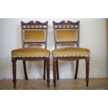 A pair of Victorian turned, carved and upholstered mahogany standard chairs