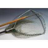 An antique fishing gaff and telescopic trout landing net