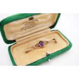 An early 20th Century yellow-metal amethyst and pearl geometric openwork bar brooch, having a