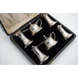 A cased George V silver cruet set, comprising pairs of pepperettes, salts and mustards, each with