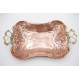 An early 20th Century copper and brass tray by Carl Deffner, embossed in a pronounced