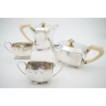 A George V silver four-piece Art Deco tea service, comprising tea pot, hot water, sugar bowl and