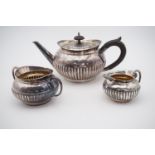 A Victorian batchelor's silver three-piece tea set, each of gadrooned oblate form with C-scroll