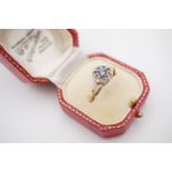 A Belle Epoque sapphire and diamond ring, having a central bezel set sapphire of approximately .