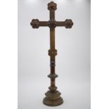 A Victorian brass alter candlestick, the terminals faced by stylized flowerhead patterae, the