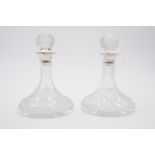 A pair of diminutive / individual serving silver-mounted and cut-glass ship's style decanters,