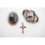 Two Victorian white-metal "pebble" brooches and a cruciform pendant, 21.8g