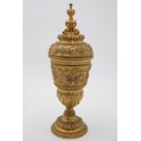 A Victorian Baroque ormolu goblet and cover, the cup bas-moulded with a frieze depicting Poseidon