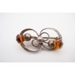 A Charles Horner silver and citrine brooch, of Art Nouveau design, in the form of two entwined