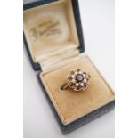 A vintage 9ct gold, garnet and pearl flower-head cluster dress ring, with central garnet of