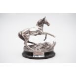 A silver sculpture of a horse rearing having been startled by a pheasant, on caveto-moulded oval