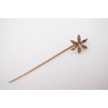 A Belle Epoque diamond and pearl stick pin, the terminal in the form of a flower, centrally set with