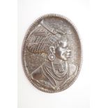 A vintage white metal brooch, bearing the reposse moulded profile portrait of a South African
