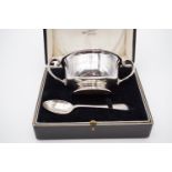 A George V cased silver presentation poringer and spoon, bowl 10.5 cm (excluding handles) x 6 cm