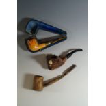 A cased meerschaum pipe and two other pipes