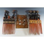 Two South African carved wooden over-sized combs and a decorative carving