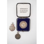 A 1935 Carlisle Musical Festival silver fob medallion, a silver cricket fob, and a Northern Counties