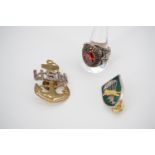 A US Marine Corps finger ring, together with a US Navy cap badge and a Vietnam War type ARVN special