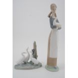 Two Nao figurines, a girl with goose, and geese